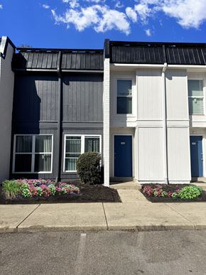 Cincinnati apartment for rent - A modern two-story building with a blue door and windows.
