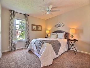 Evansville apartment for rent - a bedroom with a bed and a ceiling fan