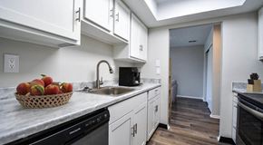 Columbus apartment for rent - a kitchen with white cabinets and a bowl of fruit on the counter