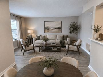 Louisville apartment for rent - A living room with a brown table and white chairs.