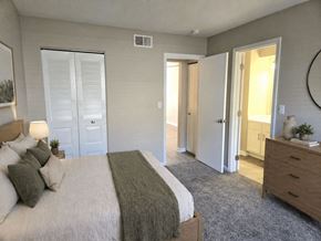 Louisville apartment for rent - A bedroom with a bed, dresser, and mirror.