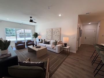Prospect apartment for rent - A living room with a brown rug and a white couch.