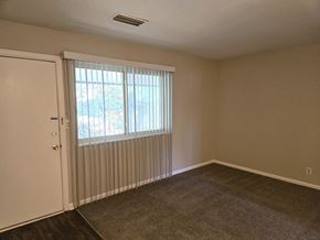 Louisville apartment for rent - an empty living room with a window and a door