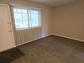 Louisville apartment for rent - an empty living room with a window and a door