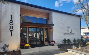 Columbus apartment for rent - a white building with a large glass door and a sign on the side of it