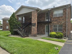 Louisville apartment for rent - A brick apartment building with a black metal staircase.