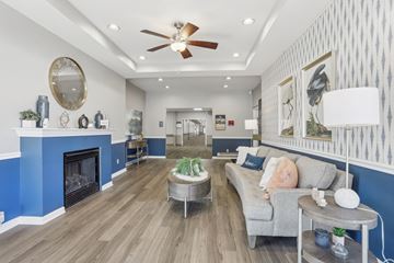Florissant apartment for rent - A living room with a grey couch and a blue fireplace.