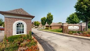 Louisville townhouse for rent - A small building with a sign that says "Ashton Park" in front of a brick wall.