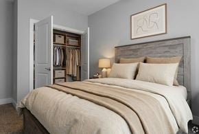 Sellersburg apartment for rent - A bedroom with a large bed and a wooden headboard.