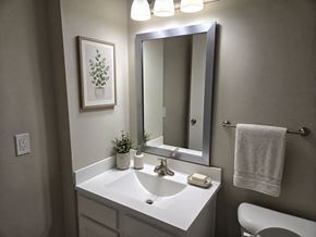 Louisville apartment for rent - A bathroom with a white sink and a mirror above it.