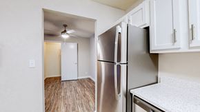 Louisville apartment for rent - A kitchen with a stainless steel refrigerator and wooden floors.