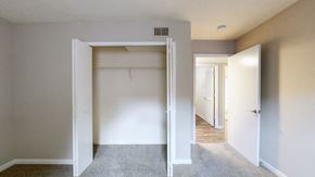 Louisville apartment for rent - A room with a carpeted floor and two open doors.