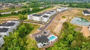 Louisville apartment for rent - an aerial view of the apartments and a pool in the middle of the city