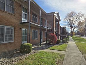 Louisville apartment for rent - A row of apartment buildings with a sidewalk in front.