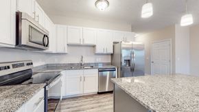Elizabethtown apartment for rent - A kitchen with white cabinets and granite countertops.