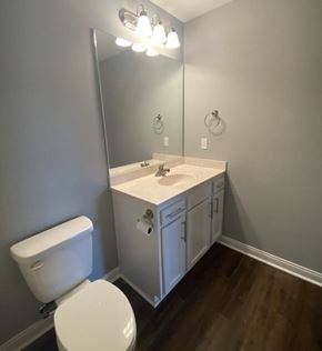 Buckner apartment for rent - A white toilet sits next to a sink in a bathroom.