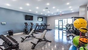Clarksville apartment for rent - A gym with a variety of equipment including treadmills, weights, and exercise balls.