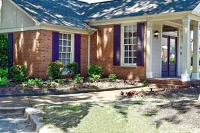 Memphis townhouse for rent - A house with purple shutters and a white door.