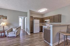Evansville apartment for rent - a kitchen and a living room with a refrigerator
