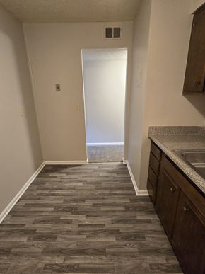 Louisville apartment for rent - A hallway with a tiled floor and a sink in the corner.
