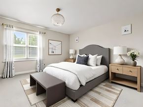 Maineville apartment for rent - A bedroom with a large bed, a nightstand, and a window with curtains.