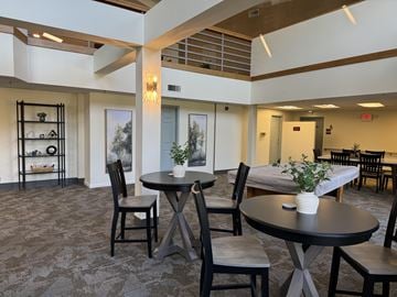 Florissant apartment for rent - a living room with tables and chairs and a bed