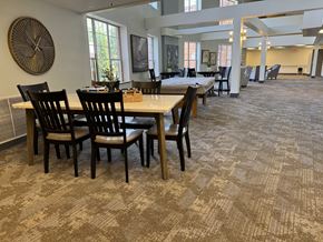 Florissant apartment for rent - a large dining room with tables and chairs in a building