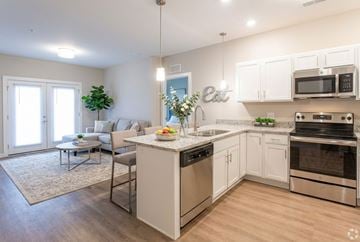 Clarksville apartment for rent - A modern kitchen with white cabinets and stainless steel appliances.