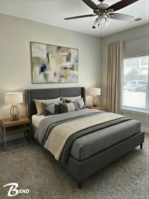 Clarksville apartment for rent - A bedroom with a large bed and a ceiling fan.