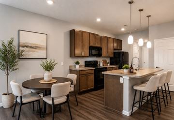 Reynoldsburg apartment for rent - A modern kitchen with a dining table and chairs.
