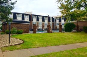 Peoria apartment for rent - a building with a yard and a pool in front of it