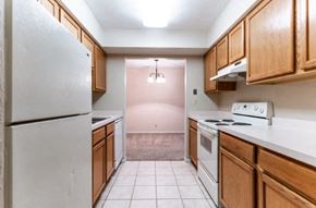 Peoria apartment for rent - a kitchen with white appliances and wooden cabinets