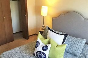 Peoria apartment for rent - a bedroom with a bed and a lamp
