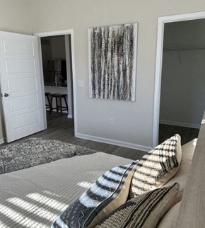 Louisville apartment for rent - a bedroom with a bed and a painting on the wall