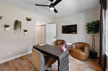 Prospect apartment for rent - A living room with a brown leather chair and a wooden table.
