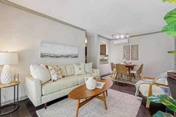Louisville apartment for rent - A living room with a white couch and a painting on the wall.
