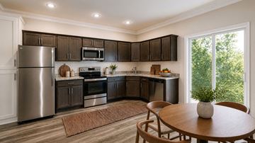 Louisville apartment for rent - A modern kitchen with dark brown cabinets and stainless steel appliances.