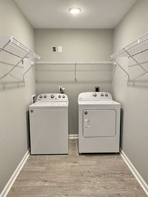 Richmond apartment for rent - two washes and dryers in a laundry room with shelves