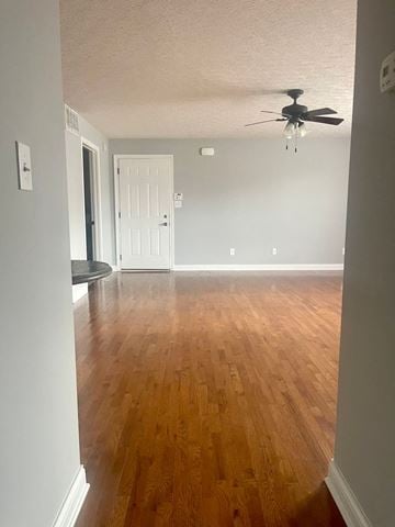 Richmond apartment for rent - an empty living room with wood floors and a ceiling fan