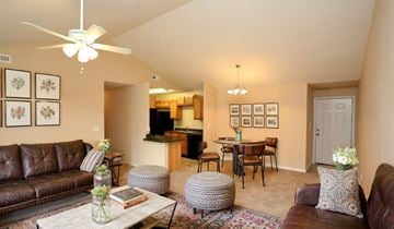 Louisville apartment for rent - A living room with a brown leather couch and a white coffee table.