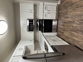 Louisville apartment for rent - A modern kitchen with white cabinets and stainless steel appliances.