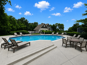 Maineville apartment for rent - A pool surrounded by chairs and a house in the background.