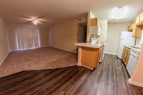 Louisville apartment for rent - an empty kitchen and living room with wood floors