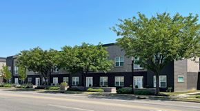 Clarksville apartment for rent - A row of houses with trees in front.