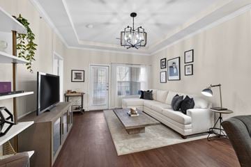 St. Louis townhouse for rent - A living room with a white couch and a wooden floor.