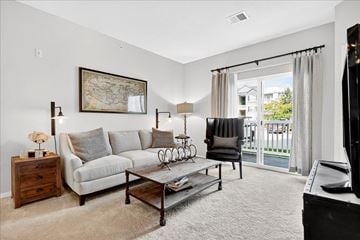 St. Charles apartment for rent - A living room with a grey couch, a coffee table, and a painting on the wall.