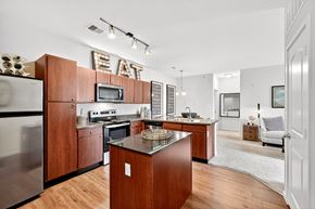 St. Charles apartment for rent - A modern kitchen with wooden cabinets and a stainless steel refrigerator.