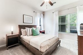 Lafayette apartment for rent - a bedroom with a bed and a ceiling fan at Plantation Crossing, Lafayette, Louisiana