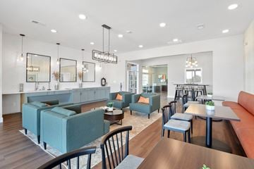 Lake St Louis apartment for rent - a living room with couches tables and chairs and a kitchen