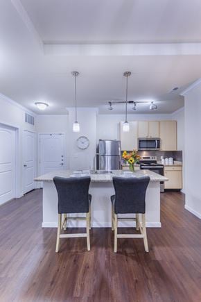 St.Louis townhouse for rent - a kitchen with a large island with two chairs in front of it at Aventura at Forest Park, St. Louis, MO 63110